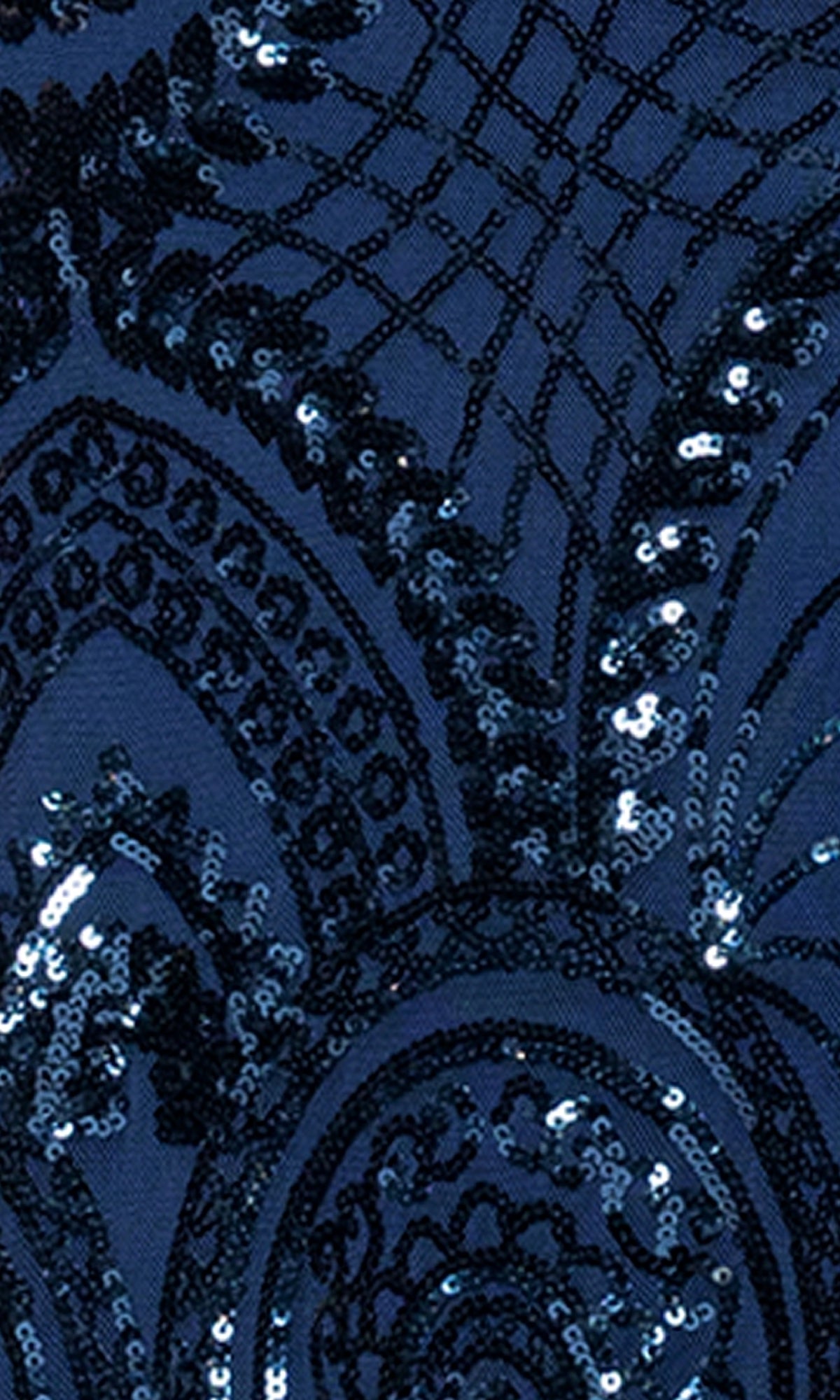 The Long Sequin-Print Prom Dress: Blondie Nites 5377BN features dark blue fabric with intricate, shiny black sequin patterns in curved and geometric designs—an elegant choice for prom or a junior prom dress.