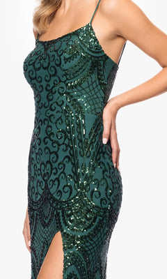 A woman in the Blondie Nites 5377BN long sequin-print prom dress, sleeveless and dark green with black ornate patterns and a thigh-high slit, poses with one hand on her hip.