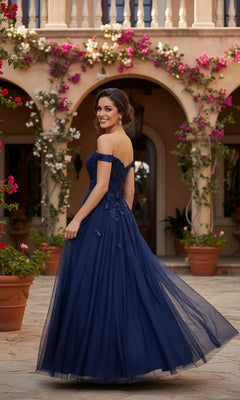 A woman in the Blush Pink Prom Dress: Blondie Nites 5389BN stands outdoors, looking back and smiling. Flowering vines and arched columns appear in the background.