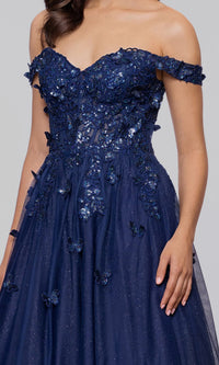 Woman wearing the Blush Pink Prom Dress: Blondie Nites 5389BN, featuring an off-the-shoulder design with floral lace embroidery and butterfly accents, corset bodice, standing against a plain background.