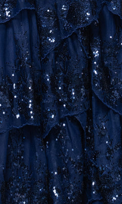 Close-up of layered navy blue fabric with sequins, lace appliques, and ruffled textures—ideal for the Long Navy Prom Dress: Blondie Nites 5394BN, featuring a shimmering tiered A-line skirt.