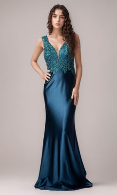 A woman stands against a plain background wearing the Nina Canacci 5411—a sleeveless, dark teal floor-length formal dress with a fitted bodice and deep V-neckline.