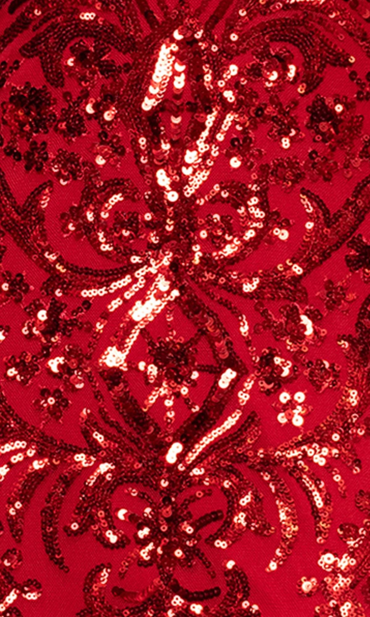 Close-up of the red fabric from the Long Prom Dress: Blondie Nites 5415BN, showing intricate sequin floral patterns that give a shiny, textured, and ornate look.