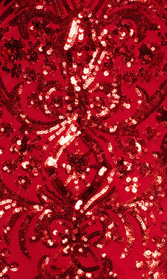 Close-up of the red fabric from the Long Prom Dress: Blondie Nites 5415BN, showing intricate sequin floral patterns that give a shiny, textured, and ornate look.