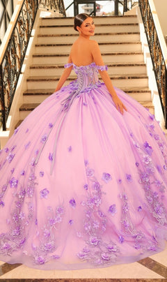 A woman stands on a staircase, facing backward and looking over her shoulder, wearing the Quinceanera Dress 54224 By Amarra—a tulle ball gown with floral embroidery.