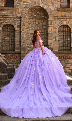 A woman stands on stone steps before a rustic building, wearing the Amarra 54231—a 3D Floral Quinceañera Dress with off-the-shoulder lavender ball gown style, perfect for a dreamy fairytale celebration.