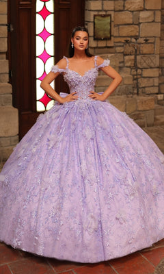 A woman poses indoors in front of a stone wall and wooden door wearing the Amarra 54243 off-shoulder quinceanera dress, featuring an elaborate lavender design with 3D floral appliques.