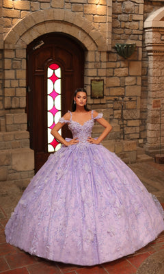 A woman stands indoors before a wooden door, wearing the Amarra 54243 off-shoulder quinceanera dress—an ornate lavender gown with a full skirt and 3D floral appliques.