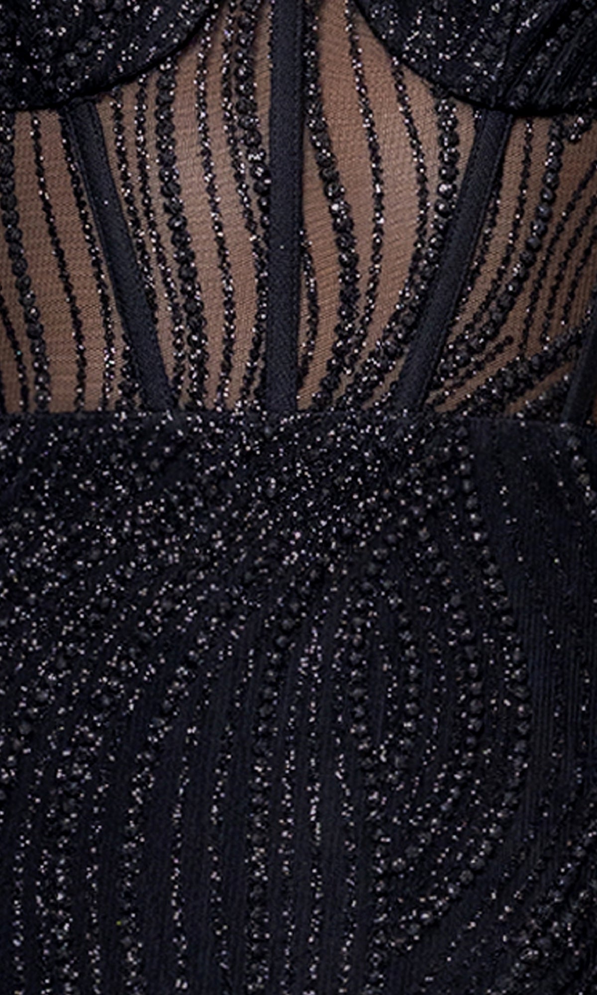 Close-up of the Blondie Nites 5426BN dress: black fabric with glittering bead embellishments in wavy vertical patterns over sheer nude mesh, ideal for a daring prom look with a sheer corset bodice.