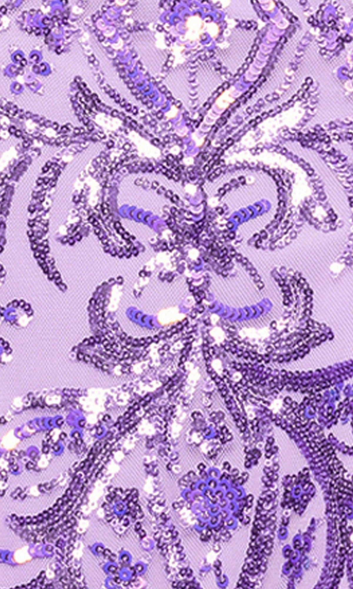 Close-up of the Blondie Nites 5428BN long prom dress, showcasing lavender fabric adorned with purple sequins in floral and swirling patterns on a light purple background.