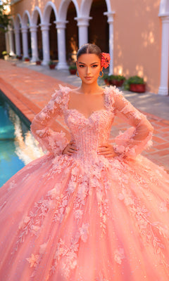 A woman in the Corset Ball Gown Quinceañera Dress 59290 by Amarra, featuring pink glitter tulle and floral details, stands by a pool before an arched building surrounded by lush plants.