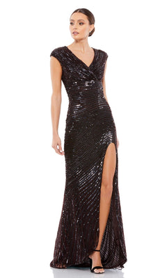 A woman models the Cap-Sleeve Sequin Formal Dress: Mac Duggal 5441, featuring cap sleeves, a V-neckline, and a thigh-high slit, styled with black heels—the ideal choice for an elegant evening look.