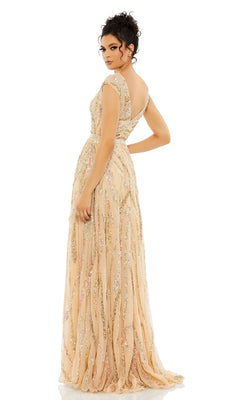 A woman stands against a white background, looking over her shoulder in the Mac Duggal 5445 High-Neck Beaded Formal Gown—a floor-length peach dress adorned with gold and silver sequins.