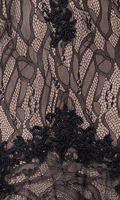 Close-up of black lace with floral and geometric designs over nude background, as seen in the Long Black Lace Prom Dress: Blondie Nites 5463BN.