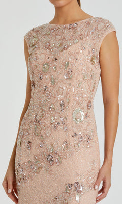 A woman wearing the Beaded Long Formal Dress: Mac Duggal 5500 in blush, detailed with intricate floral beadwork and sequins.