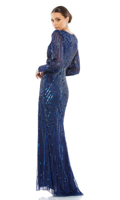 A woman poses against a white background in the Mac Duggal 5501 long sleeve sequin formal dress, floor-length and dark blue, with her back slightly turned and looking over her shoulder.