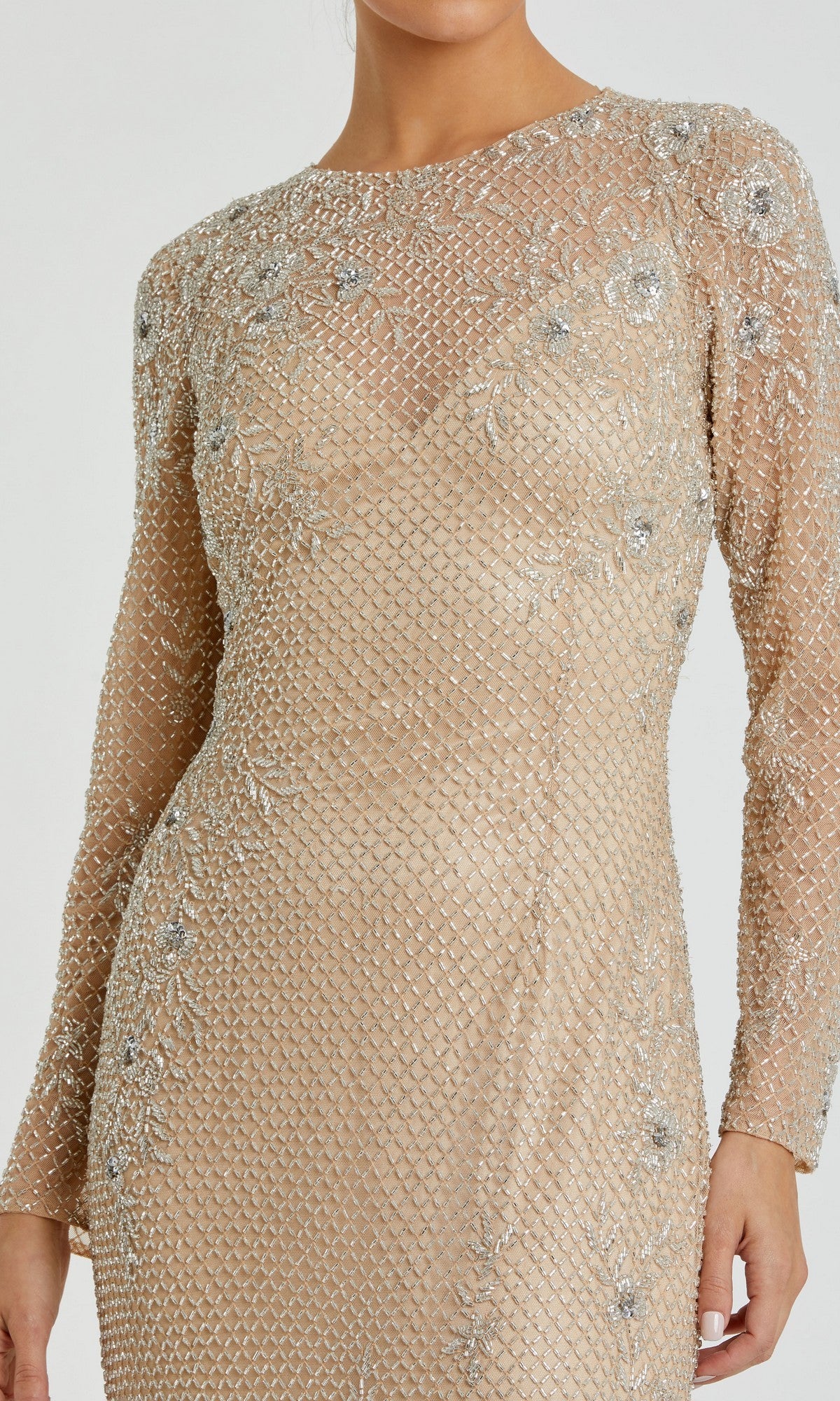 A woman wearing the Mac Duggal 5504—a long, gold beaded formal gown.
