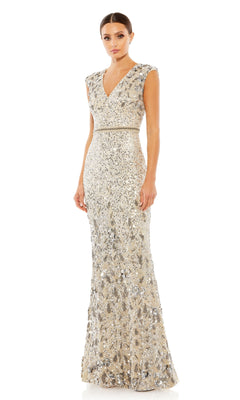 A woman wears the Long Formal Dress 5505 by Mac Duggal, a sleeveless, floor-length silver beaded gown with a bra-friendly V-neckline and fitted waist, standing against a white background.