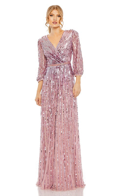 A woman stands against a white background wearing the Mac Duggal 5509 long sleeve formal dress—a pink sequin, floor-length evening gown with a V-neck and pleated details.