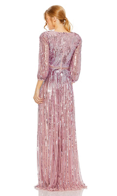 A blonde woman with a ponytail elegantly models the Mac Duggal 5509, a long sleeve, light pink sequin formal dress with sheer sleeves and vertical stripe details, shown from the back.