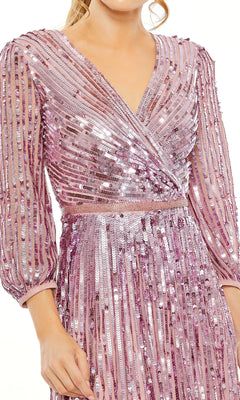 A person wearing the Mac Duggal 5509 long sleeve formal dress, featuring a fitted waist, pleated skirt, and shiny pink sequins—a truly glamorous evening look.