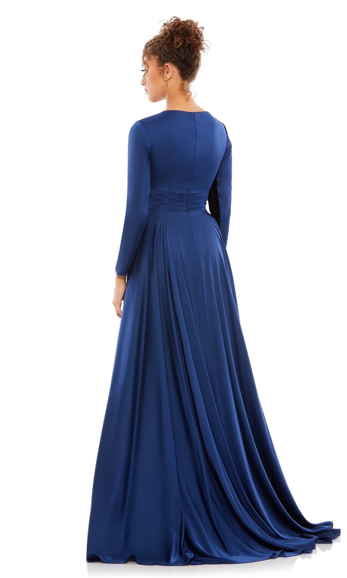 A woman faces away in the Mac Duggal 55245, a royal blue, long-sleeve satin formal dress with an a-line silhouette, highlighting its smooth back and flowing floor-length skirt.