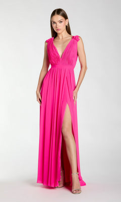A woman wears the Mac Duggal 55321 Classic Long Formal Dress in hot pink, featuring a deep V-neckline, high slit, and gathered shoulders, standing against a plain light background.