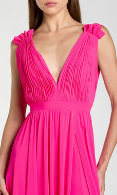 Woman wearing the Classic Long Formal Dress: Mac Duggal 55321, a bright pink, pleated evening gown featuring a deep V-neckline and gathered shoulder details.