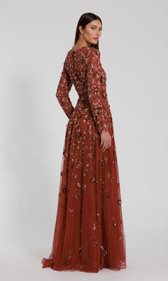 A woman wearing the Mac Duggal 5533 Beaded Long Sleeve Formal Dress stands against a plain background, looking over her shoulder.
