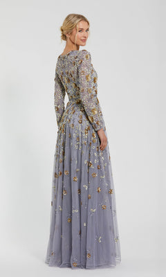 A woman poses in the Mac Duggal 5533 Beaded Long Sleeve Formal Dress—a floor-length lavender gown with floral embroidery—glancing over her shoulder against a plain white background.