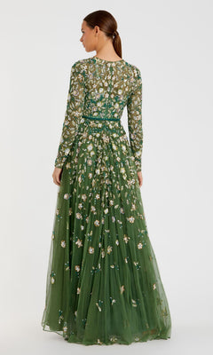 A woman with a low ponytail is seen from behind in the Mac Duggal 5533 Beaded Long Sleeve Formal Dress, an elegant floor-length green gown with floral embroidery, posed against a plain background.