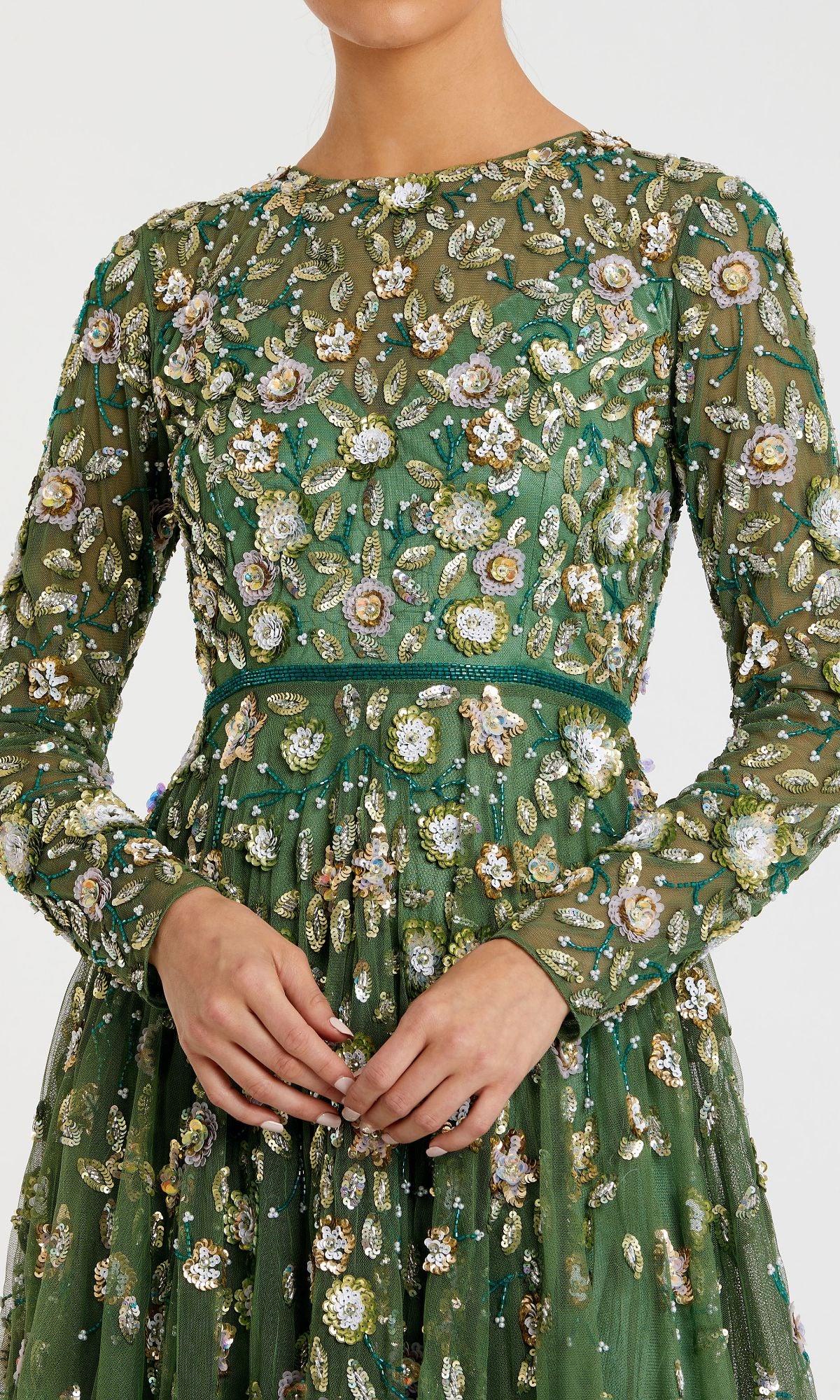 A person wearing the Mac Duggal 5533 Beaded Long Sleeve Formal Dress in green, featuring intricate floral embroidery and embellishments, shown from shoulders to waist.
