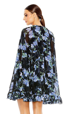 Woman with brown hair in a low ponytail, viewed from the back, wearing the Mac Duggal 55404 Short Print Cape Hoco Dress—sheer black with a blue and purple floral print.