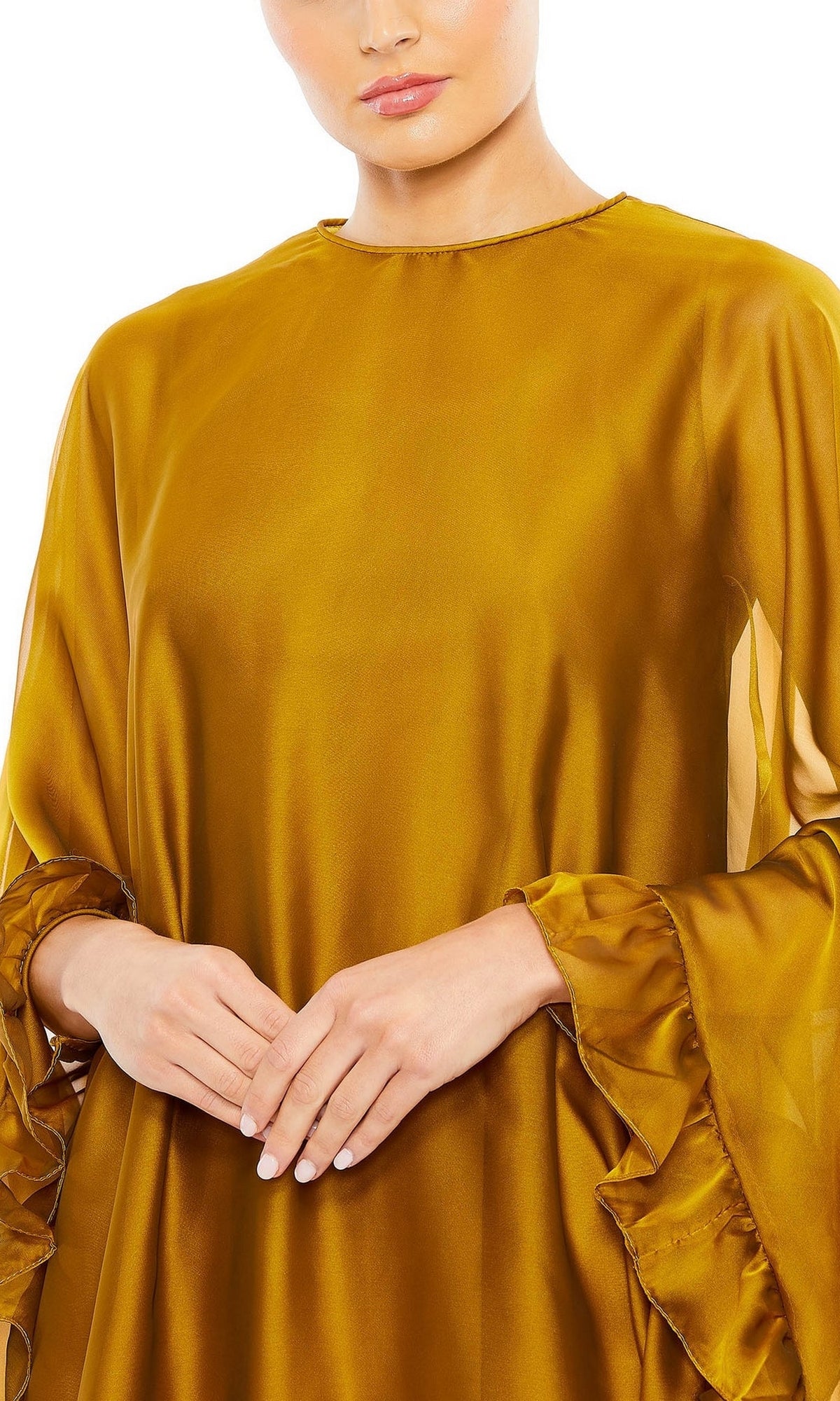 A woman stands with her hands folded, radiating elegance in the Mac Duggal 55407 Cape-Sleeve Short Ruffled Party Dress—a semi-formal cocktail dress featuring cape sleeves and stylish ruffles.