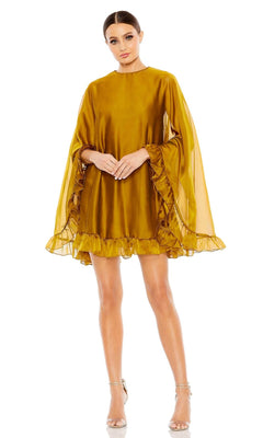 Woman in the Mac Duggal 55407 Cape-Sleeve Short Ruffled Party Dress, mustard yellow with ruffled hem and sleeves, paired with silver high-heeled sandals, stands against a white background.