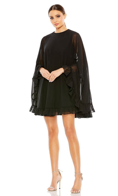 Woman in a black Mac Duggal 55407 cape-sleeve short ruffled party dress and silver high-heeled sandals stands against a white background—a chic semi-formal cocktail outfit for any occasion.