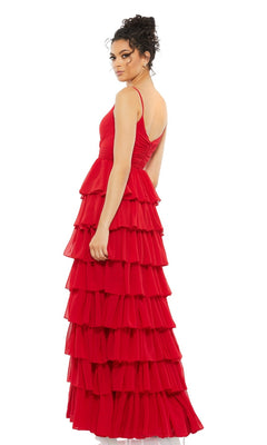 A woman stands sideways, looking back over her shoulder, wearing the sleeveless, floor-length Mac Duggal 55416 Ruffled Long A-Line Prom Dress in red against a plain white background.