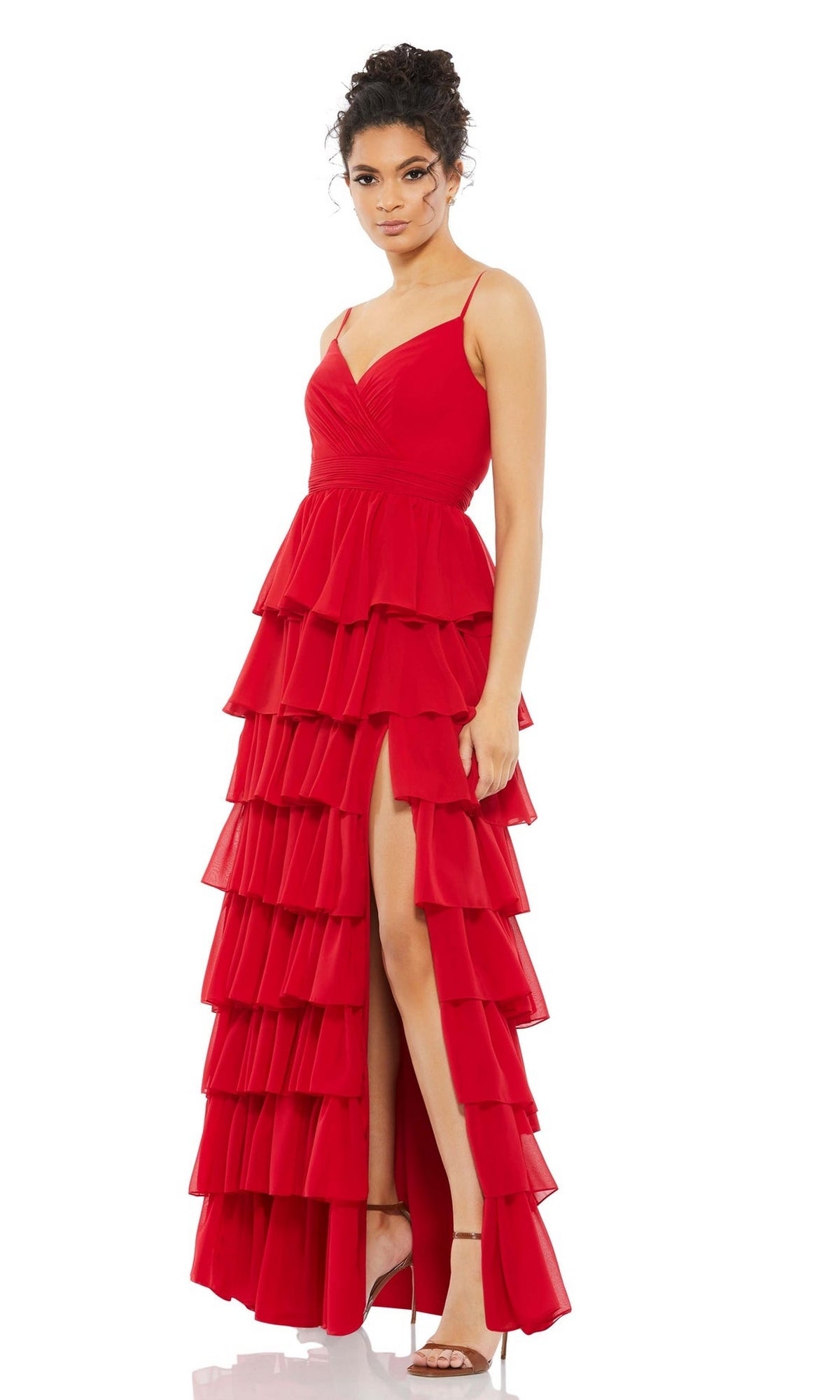 A woman models the Mac Duggal 55416 Ruffled Long A-Line Prom Dress, a sleeveless gown with tiered ruffles and a thigh-high slit, paired with high-heeled sandals against a white background.