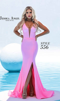 A woman stands by a pool in the Jessica Angel 556, a fitted, floor-length mermaid prom dress featuring a plunging V-neckline and front slit.