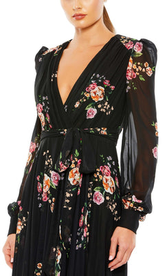 Woman wearing the Mac Duggal 55661 Long Black Print Formal Dress—a long-sleeve, V-neck, floral-print gown with waist tie, perfect for any formal evening occasion.