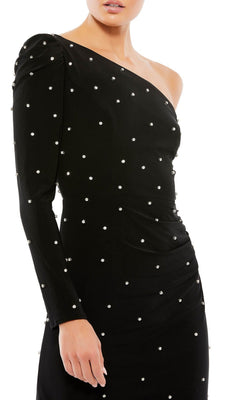 A person wearing the Short Black Pearl Hoco Dress: Mac Duggal 55667, a one-shoulder black homecoming dress featuring long sleeves and pearl-like embellishments.