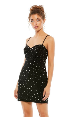 A woman wears the Pearl-Embellished Short Black Cocktail Dress 55678, a fitted short dress with thin straps and a sweetheart neckline, standing against a plain background.