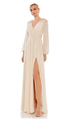 A woman wears the Mac Duggal 55694, a long sleeve chiffon formal dress with a deep V-neckline, shoulder embellishments, and high slit, paired with strappy heels—an elegant mother of the bride choice.