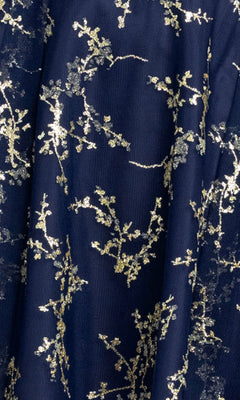 The Mini Glitter Hoco Dress: Blondie Nites 5569BN features dark blue fabric adorned with gold floral branch patterns, creating a stunning look that's perfect for an affordable homecoming dress or a chic mini hoco dress.