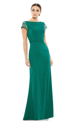 A woman in the Long Formal Dress 55718 by Mac Duggal, an emerald green, floor-length fitted gown with short beaded sleeves, stands against a plain white background.