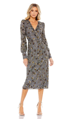 A woman wears the Short Semi-Formal Dress 5571 by Mac Duggal, a charcoal beaded, long-sleeve, knee-length dress with floral patterns and gold accents, paired with beige high-heeled sandals.
