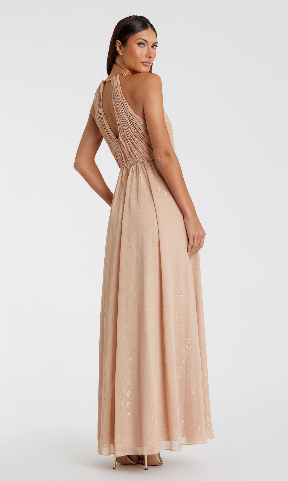 A woman wears the High-Neck Long Nude Formal Dress: Mac Duggal 55822, a sleeveless, floor-length gown with gathered back detailing, standing against a plain white background.