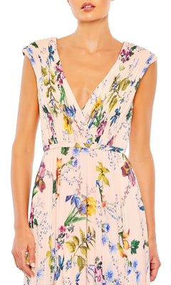 A woman wears the Mac Duggal 55829 Long Floral-Print Formal Dress, featuring a sleeveless V-neck, pleated bodice, and pastel floral print for an elegant evening look.