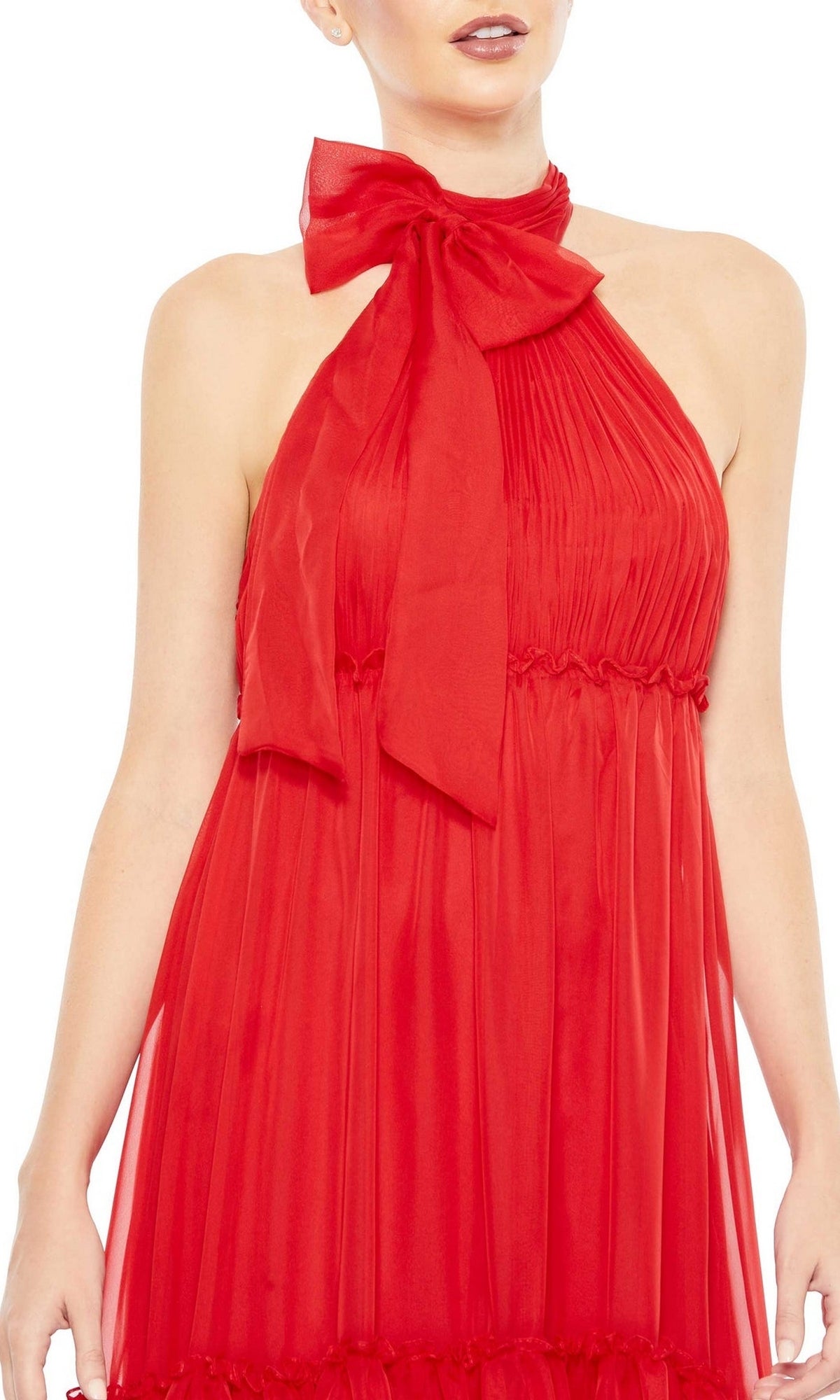 A person models the High-Neck Long Formal Dress: Mac Duggal 55848, a sleeveless red gown with pleats and a large neck bow, shown from shoulders to mid-thigh against a white background.