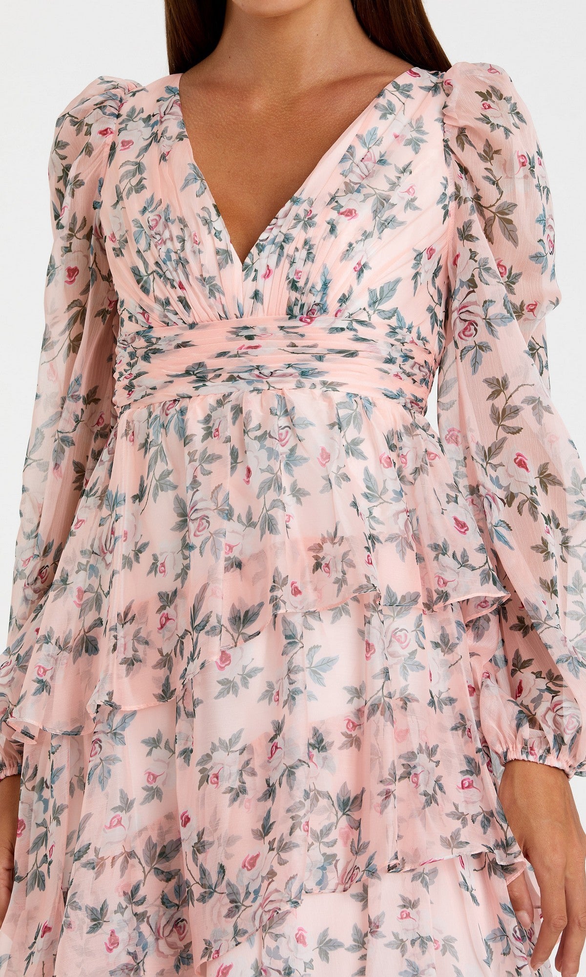 Woman in the Mac Duggal 55880 Print Midi Wedding Guest Dress—light pink with long sleeves, floral print, V-neckline, and tiered ruffle layers. An ideal choice for wedding guests.